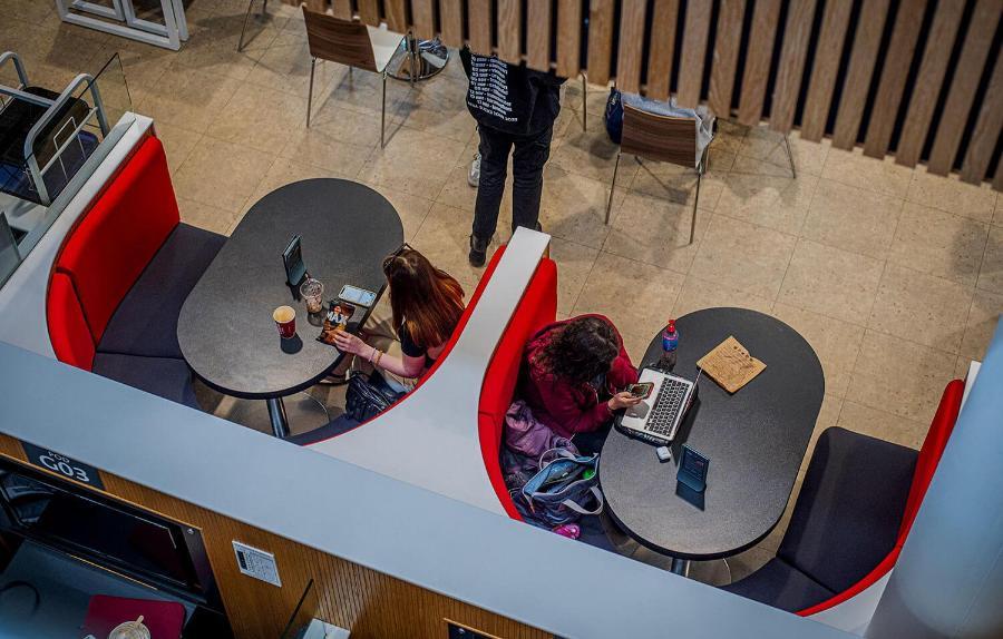 An aerial view of the booths in Commons, with people eating and working