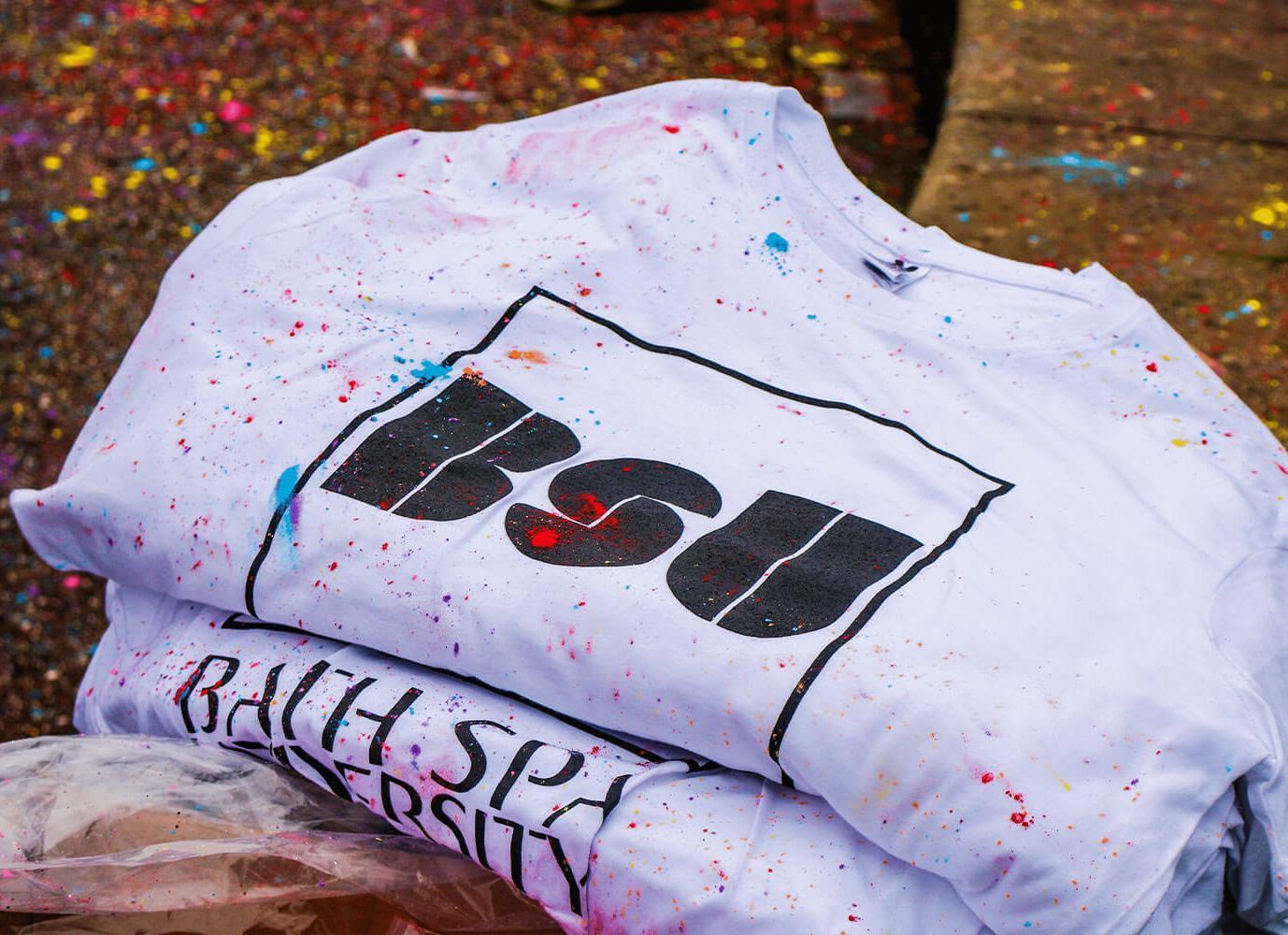 A white Bath Spa University t-shirt with paint splatters on it